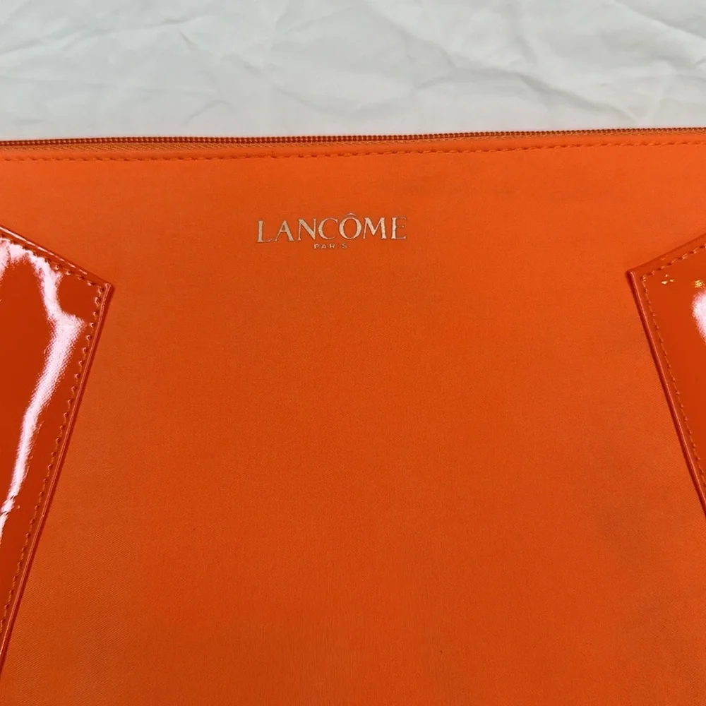 BEAND NEW! Vibrant Orange Cosmetic Bag with Glossy Finish and Zipper Closure.